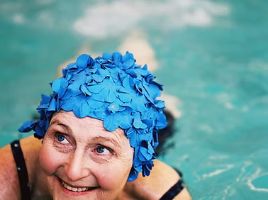 A Senior Swimmer with a blue swim cap